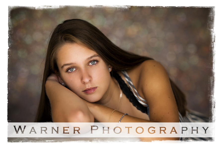 A studio portrait of Midland High School senior Jenna at the Warner Photography Studio in warm tones