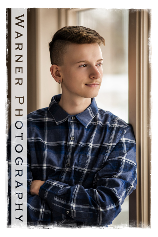 Traditional senior portrait of Dow High School senior Chad by the window at Warner Photography studio