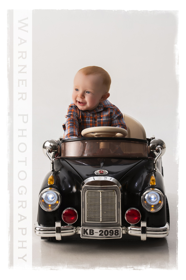 Classic year of memories portrait of Hudson for his 9 month session in his toy car at Warner Photography