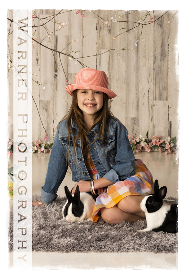 Holiday Easter portrait of Zoey with bunnies and spring flowers at the Warner Photography Studio