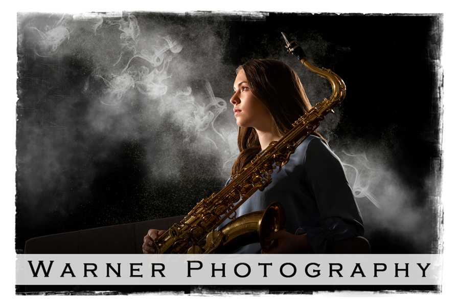 Studio portrait of Midland High School senior Hannah with her saxaphone and smoke