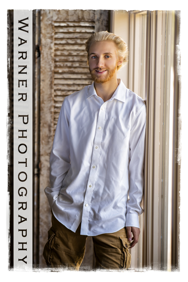 A studio portrait of Dow High School senior Nathan by the window in the studio