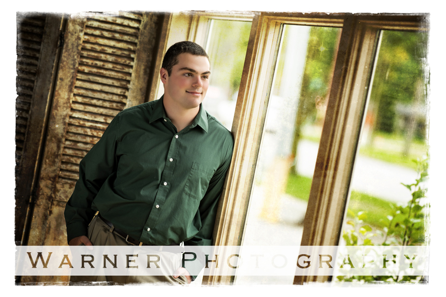 studio portrait of Bullock Creek High School senior Jacob by a window at the Warner Photography Studio
