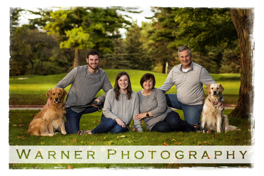 Outdoor family portrait of the Millhisler family with their dogs