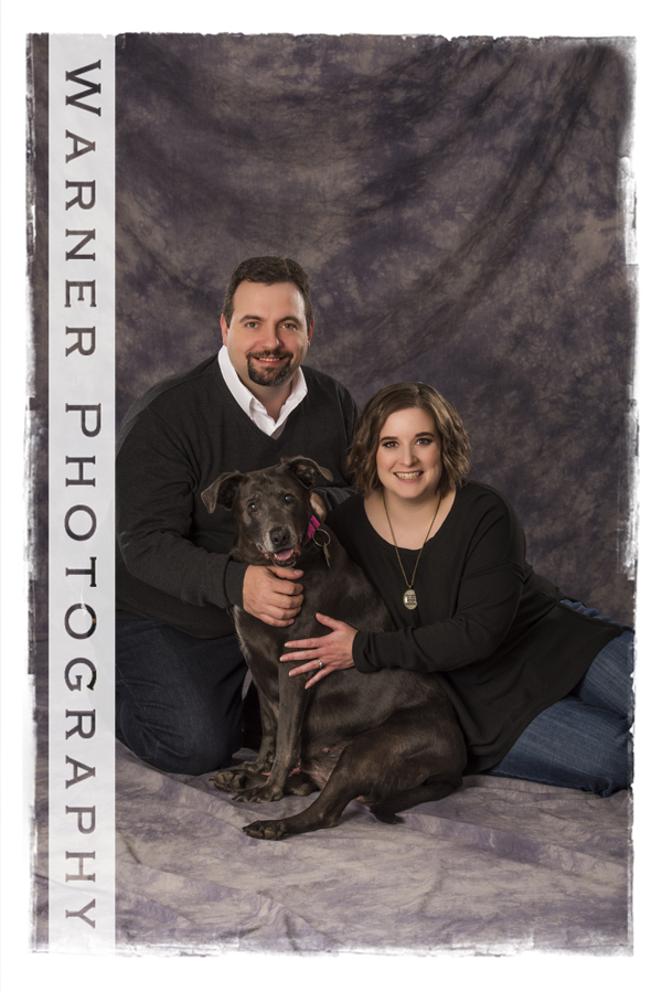 Studio portrait of the Banker family and their dog Pheonix a chocolate lab