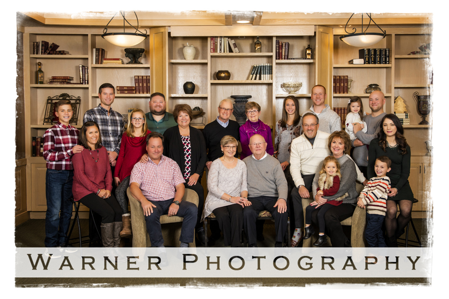On location family portrait of the Thomas family by bookshelves