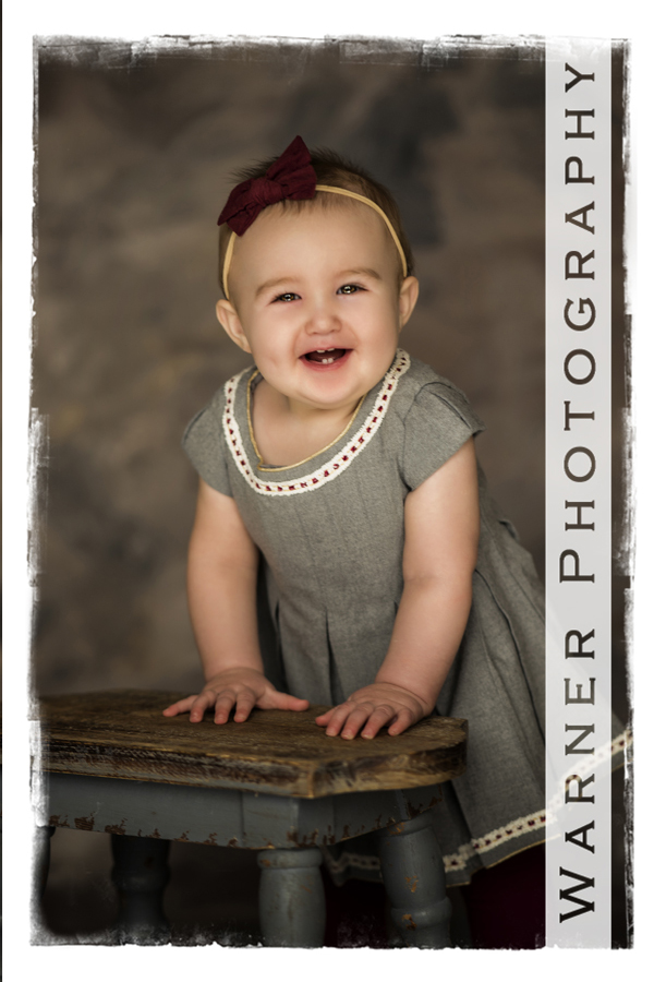 Studio portrait of Evely with a small bench