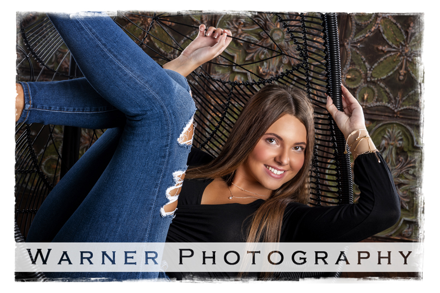 Senior portrait of Dow High School senior Alexis in a chair at Warner Studio