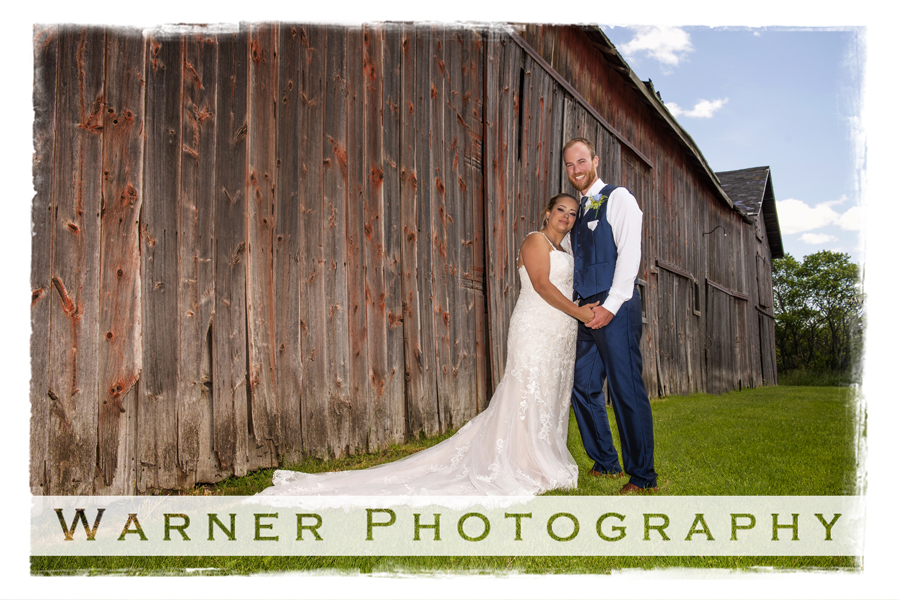 Wedding portrait of Nicole and Ryan outdoor by a barn on private property