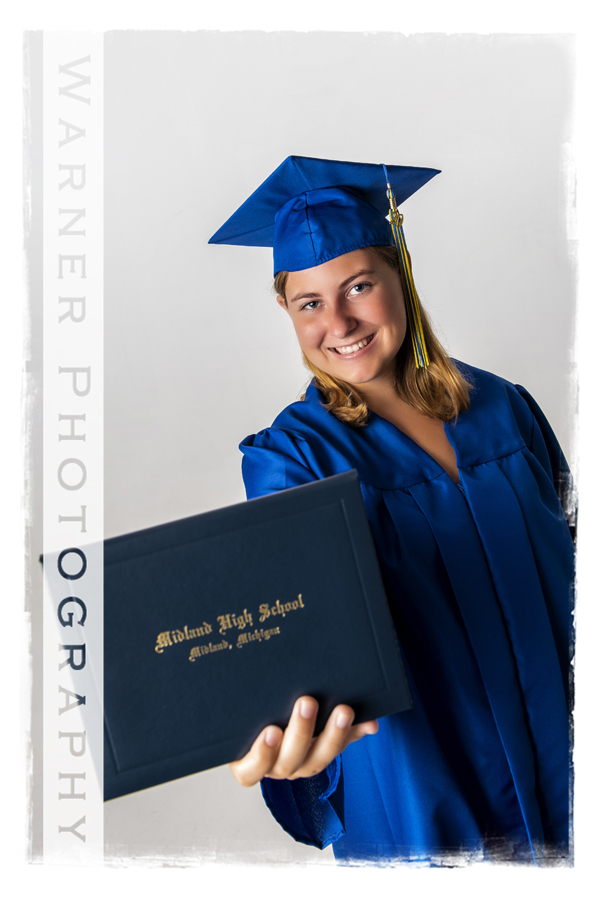 a studio portrait of Midland High School graduate Danielle in her cap and gown