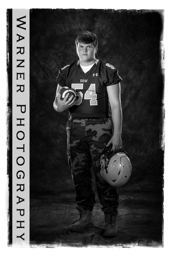 Studio portrait of Dow High School senior Jason in his football jersey