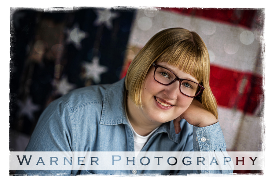 Studio portrait of Midland High School senior Marissa with the American flag