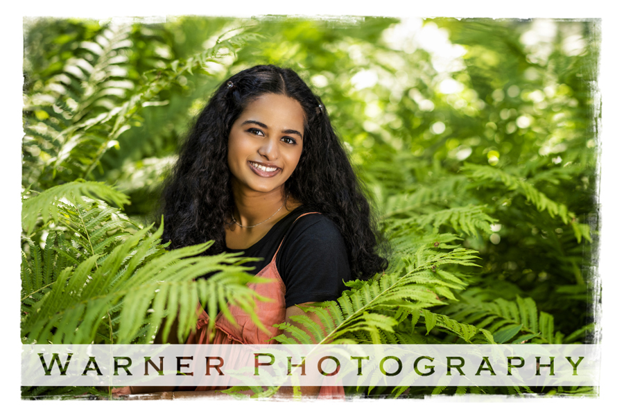 Outdoor senior portrait of Midland High School senior Meghana at Dow Gardens in the green ferns