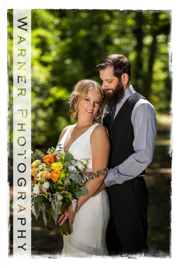 outdoor wedding portrait of Sara and Brandon with her boquet of flowers