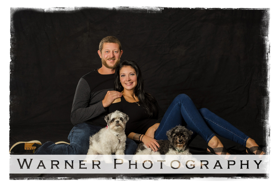 Studio portrait of Kerey and Justin with their two dogs