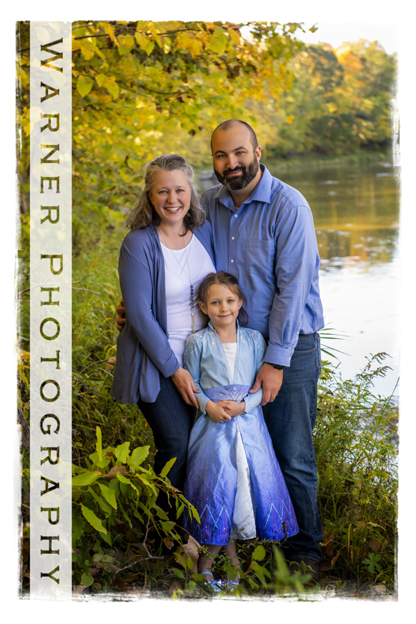 An outdoor portrait of the Brown family at Chippewa Nature Center by the river