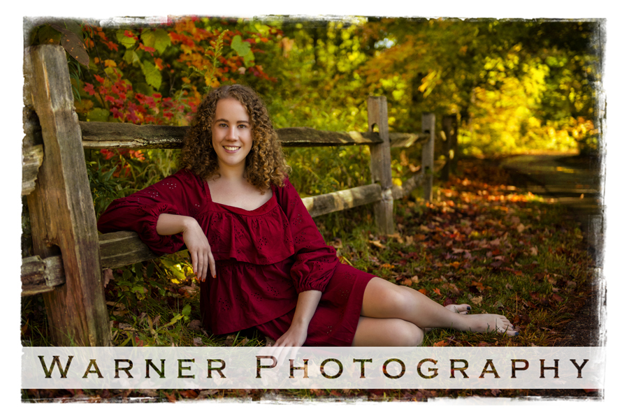 an outdoor portrait of Okemos High School senior Lily at Chippewa Nature Center by fall leaves