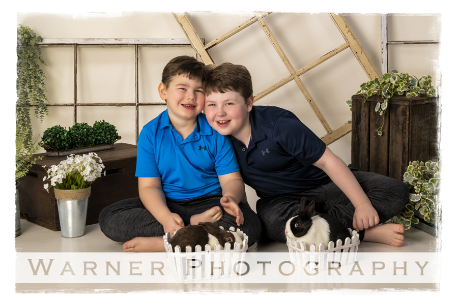a portrait of Brady and Carson at the studio with bunnies
