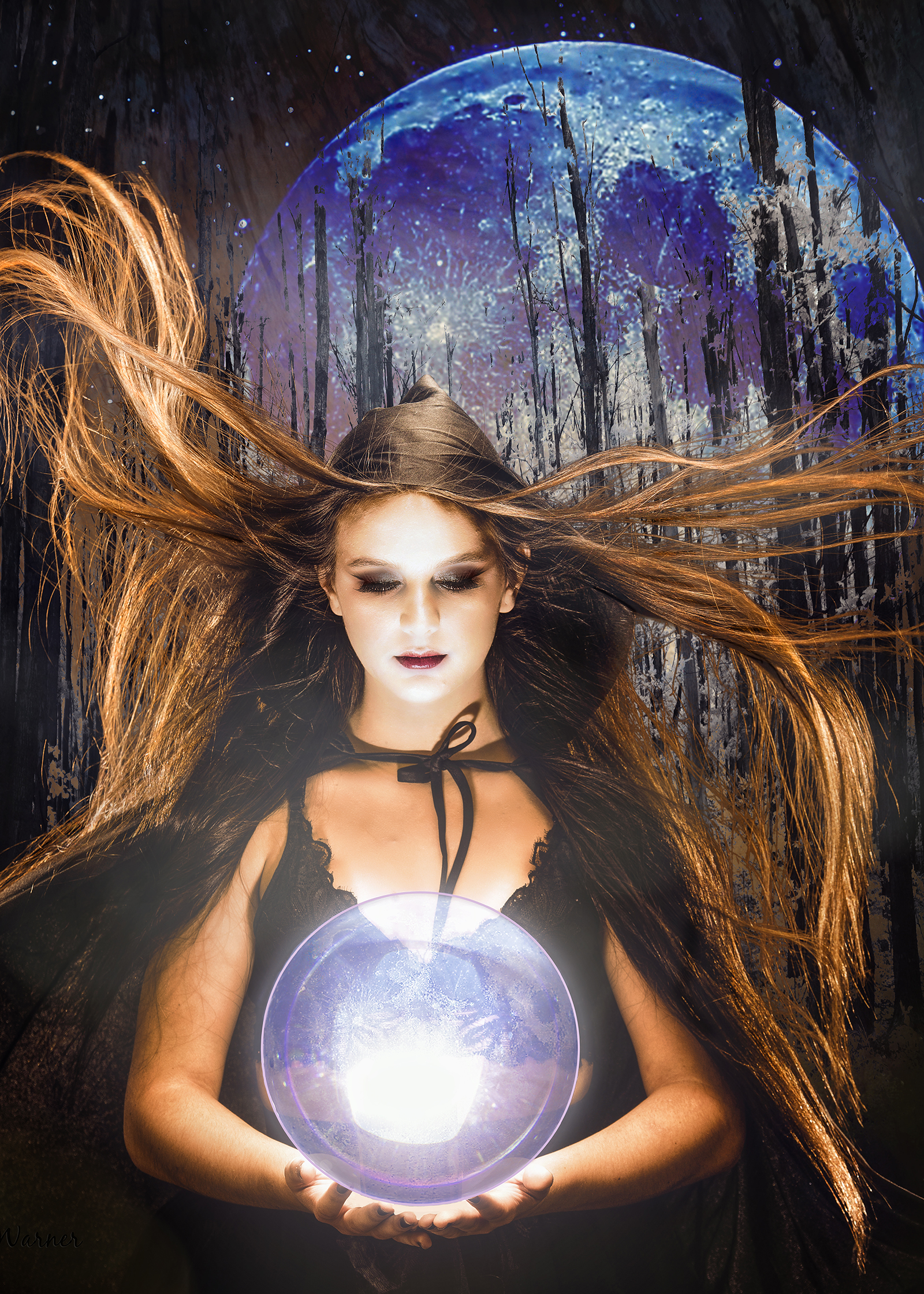 an artistic portrait of Taylin at the studio with a cape and crystal ball