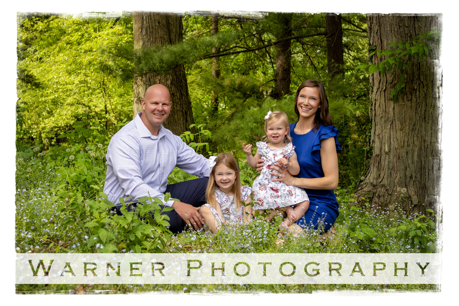 an outdoor portrait of the Briston family at Dow Gardens