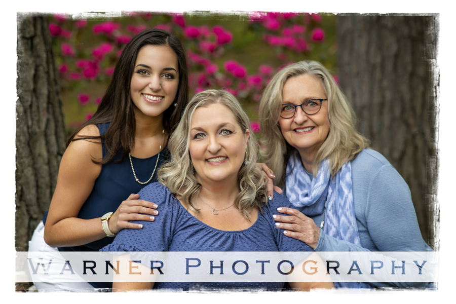 an outdoor family portrait of the Luebkert family at Dow Gardens with pink flowers