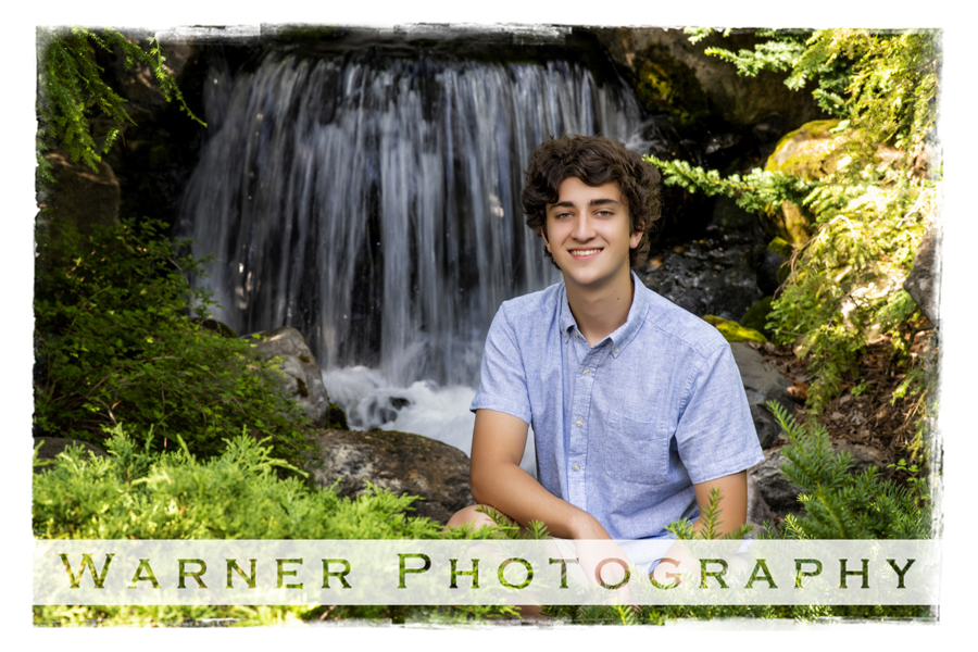 an outdoor portrait of Dow High School senior Elijah at Dow Gardens
