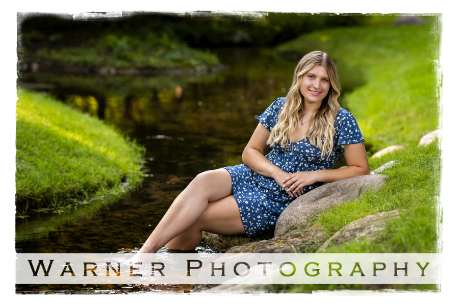 an outdoor portrait of Posen High School senior Abigail at Dow Gardens by a stream