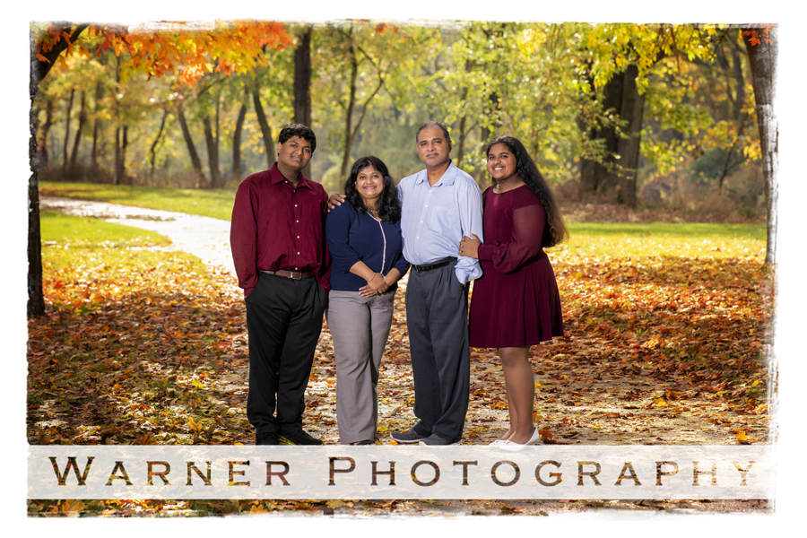 an outdoor family portrait of the Biju family at Dow Gardens with fall trees