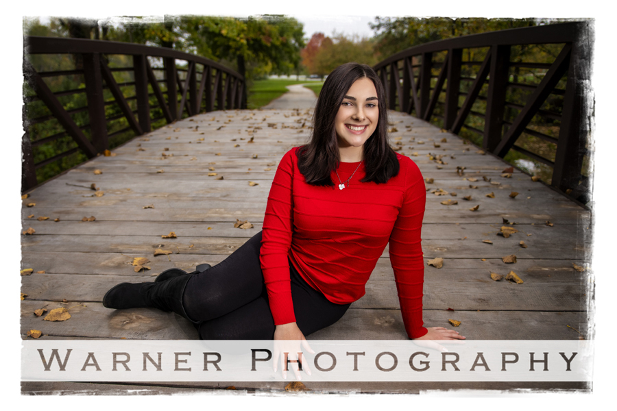 an outdoor portrait of Michigan Connections Academy senior Paige on the bridge at City Forest in Midland