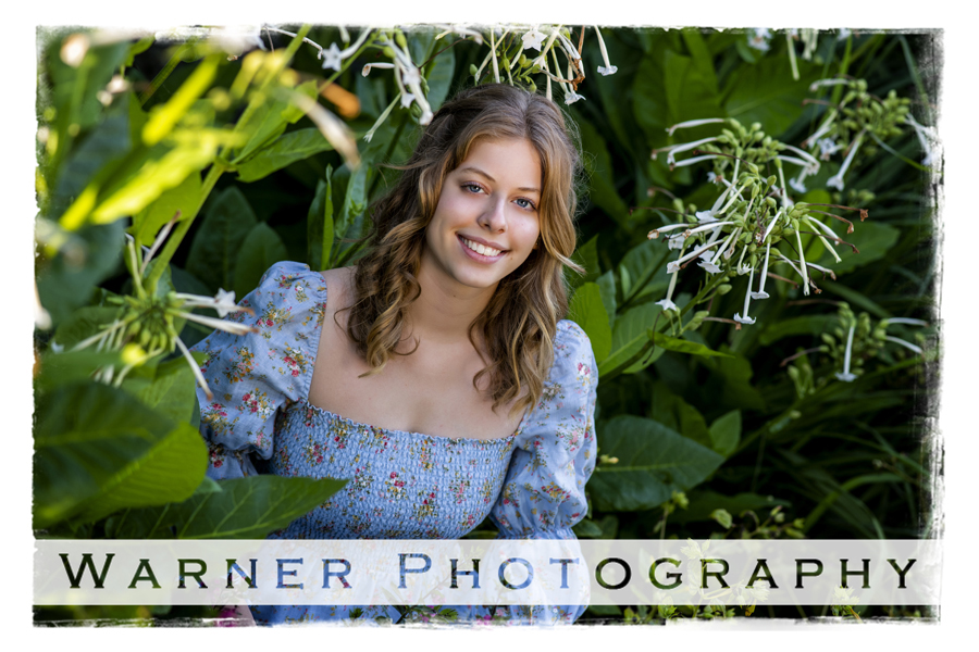 an outdoor portrait of Dow High School senior Sophia at Dow Gardens