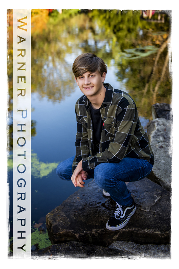 an outdoor portrait of Midland High School senior Ben at Chippewa Nature Center by the river